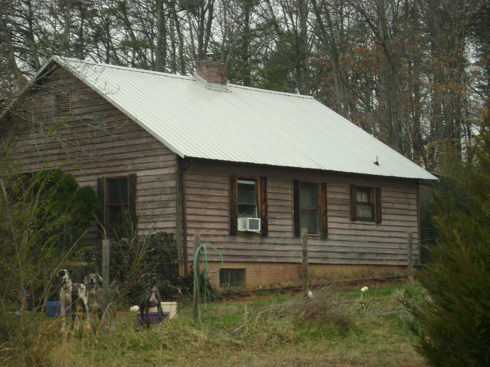 White metal roof on an old wood sided farmhouse, from a Metal Roof Installation job in Pauls Valley